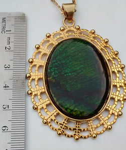 Oval Shaped Green Colored Ammolite in a Gold Colored Setting Necklace