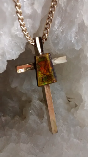 Ammolite stone on large gold colored cross with chain